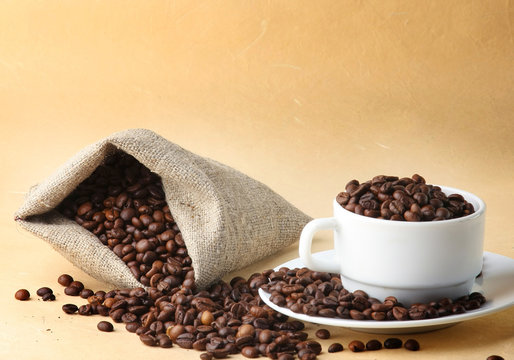 A sack of coffee beans and a cup