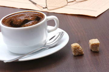 Cup of coffee and newspaper