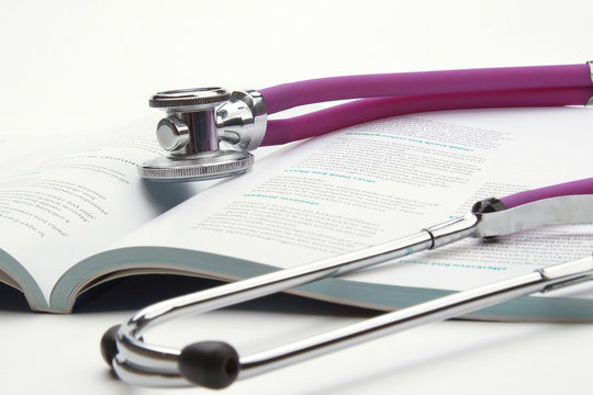 book and stethoscope isolated on white background