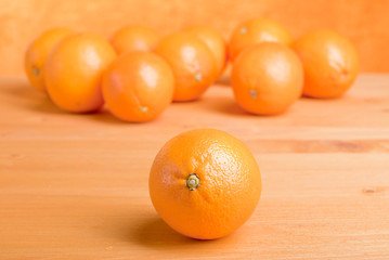 Beautiful ripe oranges on the table and a yellow orange backgrou