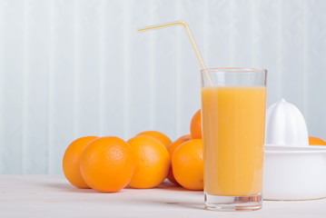orange juice beside delicious ripe oranges on the table