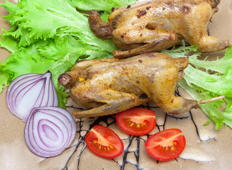 woodcocks fried with vegetables on a plate close-up