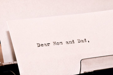 Text Dear Mom and Dad typed on old typewriter