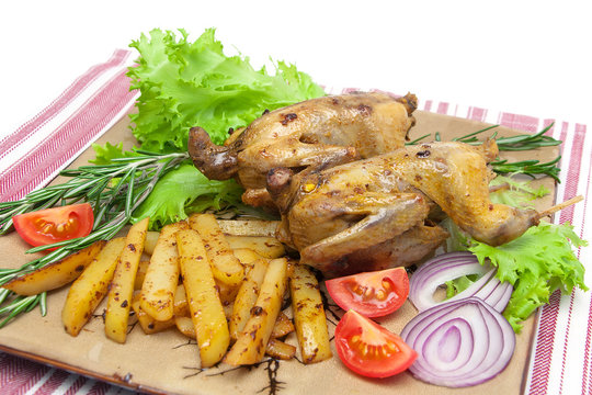 appetizing carcass woodcock with vegetables on a plate close-up