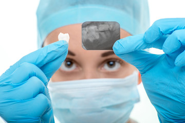 Dentist looking at dental x-ray