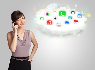 Young woman presenting cloud with colorful app icons and symbols