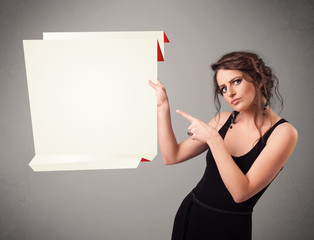 Young woman holding white origami paper copy space