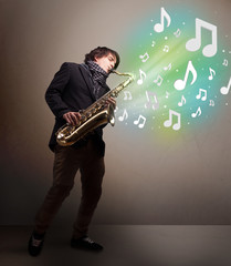 Young musician playing on saxophone while musical notes explodin