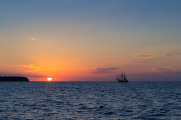 Naklejka na ściany i meble Sunset with sailing ship