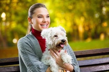 Young  girl hugging  her dog