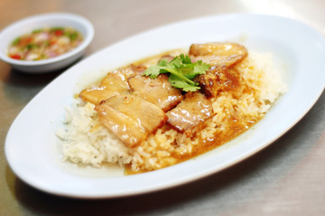 close up chinese steamed pork and rice in plastic dish