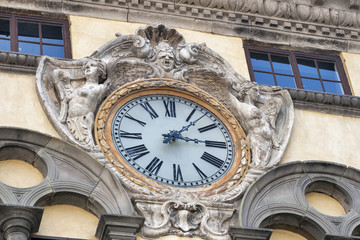 clock on a public building of Lucca, Italy