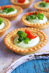 Tartlets with greens and vegetables with sauce