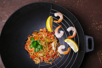 Chinese noodles with vegetables and seafood in wok