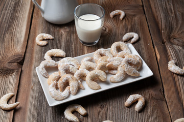 Vanille cookies and milk on a wooden table