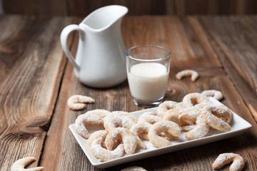 Vanille cookies and milk on a wooden table