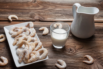 Vanille cookies and milk on a wooden table