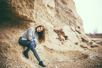 Fototapeta premium Pretty young woman outdoor in quarry with sand