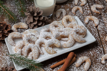 Vanille cookies and milk on a wooden table - 74684778