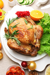 Baked chicken for festive dinner. Christmas table setting
