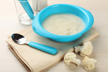 Fresh baby food in bowl with spoon