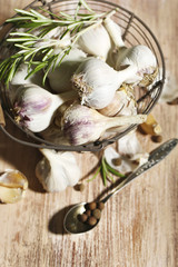 Raw garlic and spices on wooden table