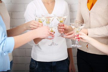 Woman hands with glasses of martini close-up