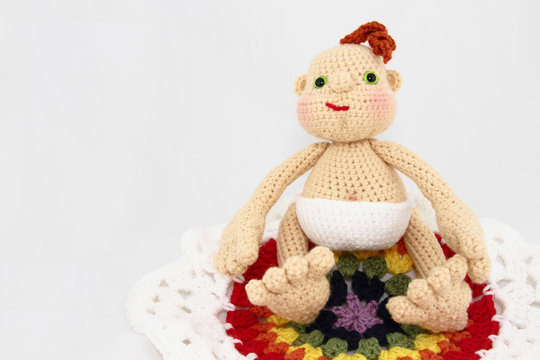 – HandCrafted Crochet Baby Doll On Colorful Blanket