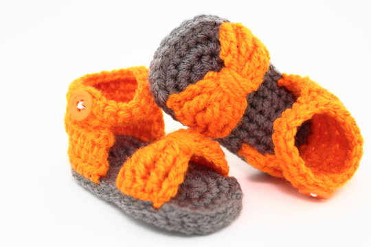 A Pair Of Handcrafted Baby Sandals In Orange And Gray