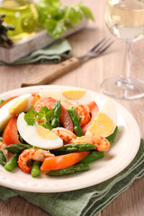 Fototapeta na wymiar Fresh salad with asparagus, eggs, shrimp and tomatoes