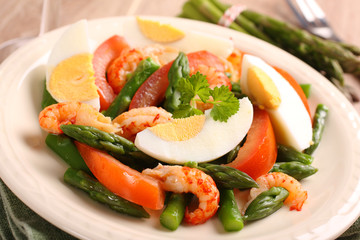 Fresh salad with asparagus, eggs, shrimp and tomatoes