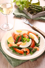 Fresh salad with asparagus, eggs, shrimp and tomatoes