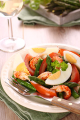Fresh salad with asparagus, eggs, shrimp and tomatoes