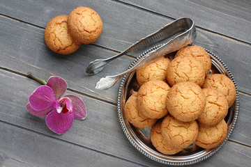 Almond cookies with sugar tongs and orchid