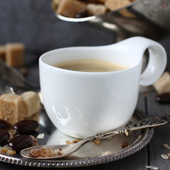 Cup of coffee, sugar cubes and chocolate candy