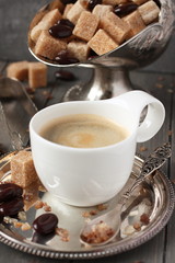 Cup of espresso, sugar cubes and chocolate