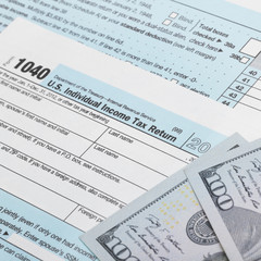 USA Tax 1040 Form 1040 and 100 US dollar bills