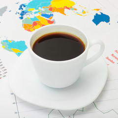 Coffee cup above world map