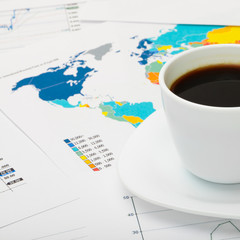 Coffee cup over world map - business concept