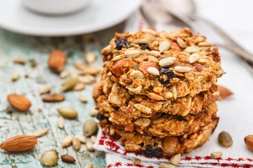 Rolgordijnen Homemade oatmeal cookies with seeds and raisin © Vankad