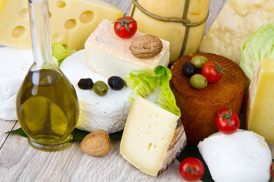 Various types of cheese on wood