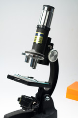 Black microscope on a white background.