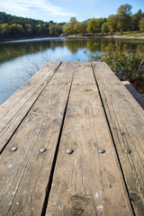 Perspective of wooden picnic table with blur landscape