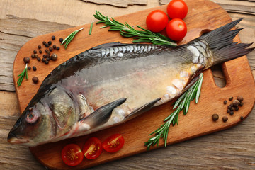 Fresh raw fish and food ingredients on table