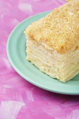 Napoleon cake on plate on table close-up
