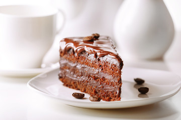 Delicious chocolate cake on plate on table on light background