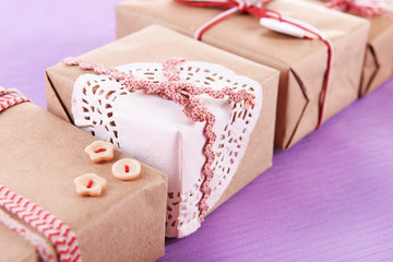 Group of handmade present boxes on purple background