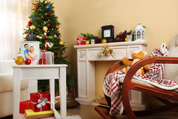 Beautiful Christmas interior with decorative fireplace and fir