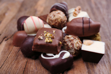 Pile of chocolate candy on wooden rustic background