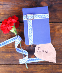 Happy Father's Day with gift box, ribbon, red carnation and